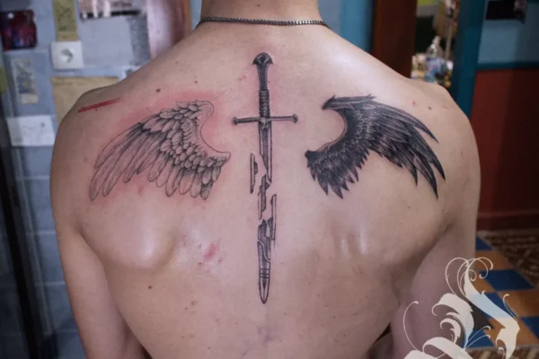 angel wings back tattoo with broken sword